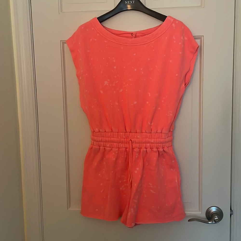 Bright jersey romper with splatter pattern.